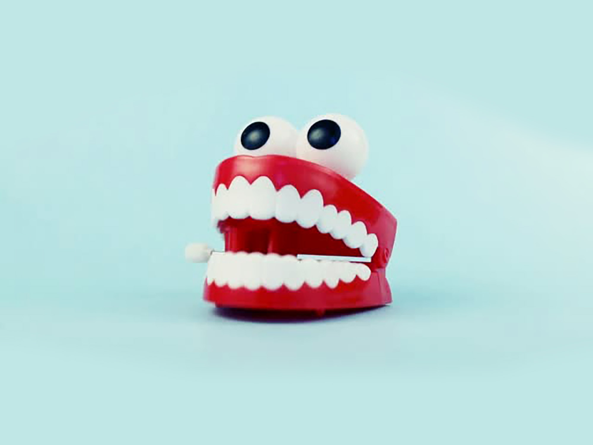Сhattering teeth toy on blue background.